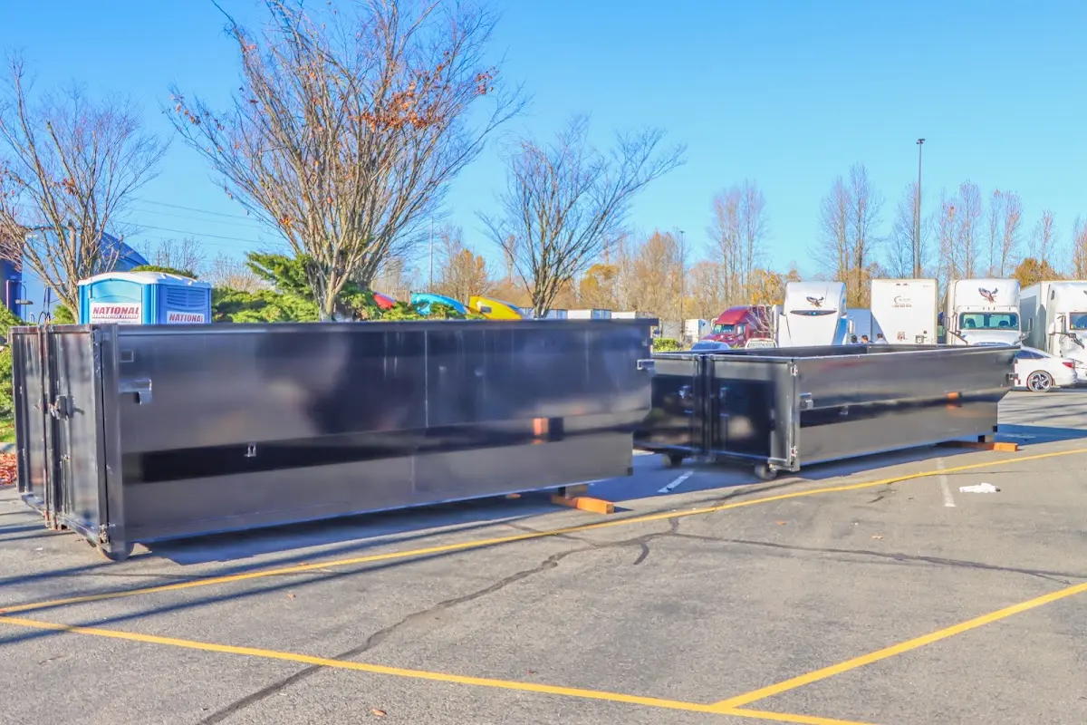 Professional dumpster rental service with roll-off container on residential driveway in Royalton